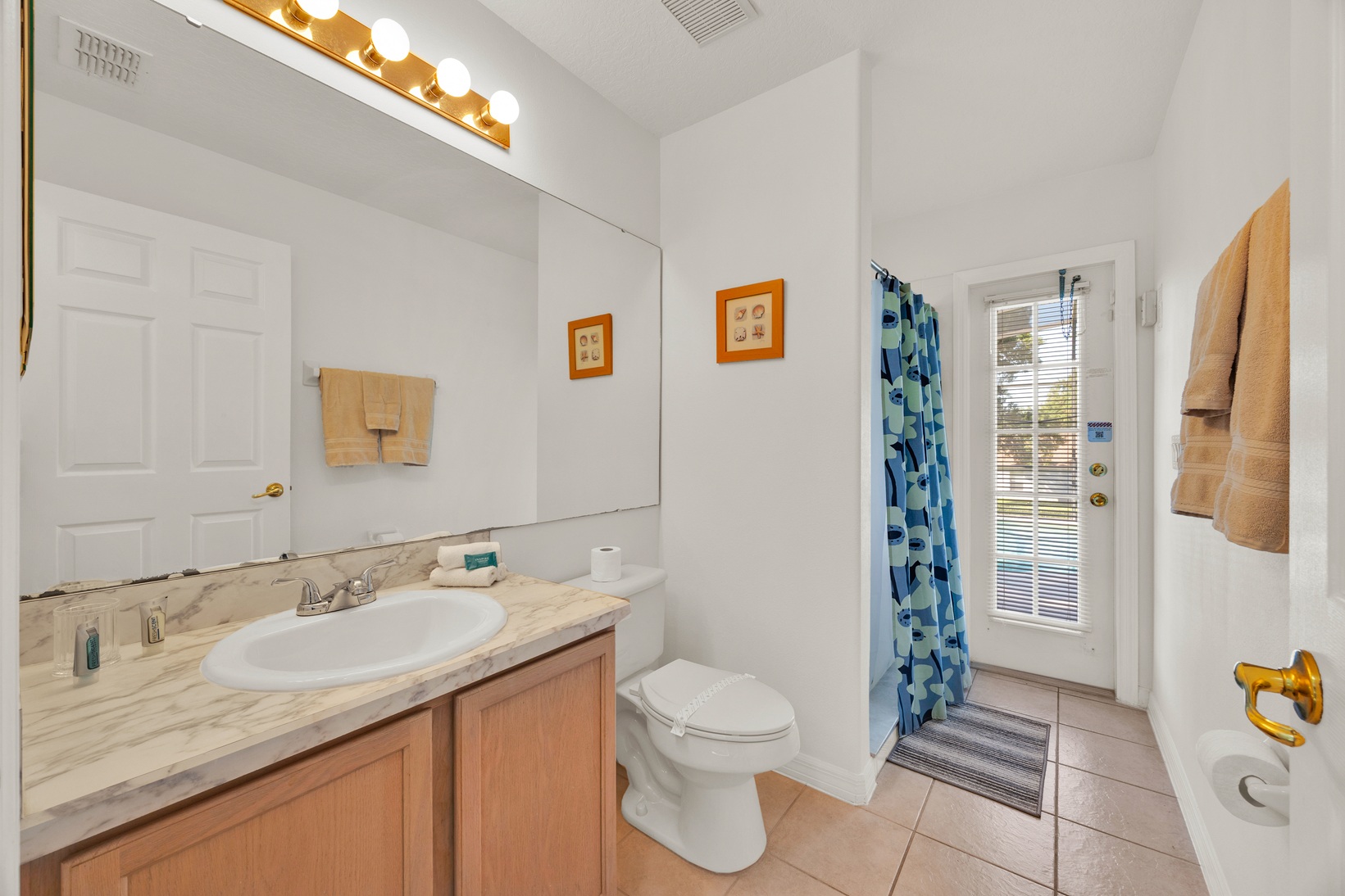 Clean guest bathroom servicing the queen room